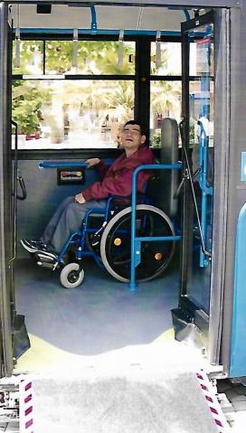 male wheelchair user on a city bus